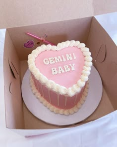 a heart shaped cake in a box with the words germin baby written on it