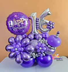 a purple balloon bouquet with balloons in the shape of flowers and numbers for a 16th birthday