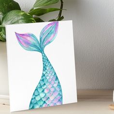 a painting of a blue and pink mermaid tail on a white background art board print