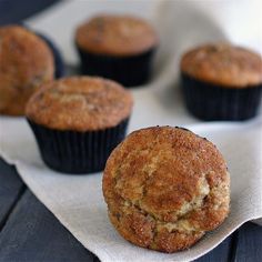 several muffins sitting on top of a white napkin