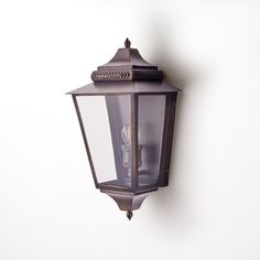 an old fashioned wall light on a white wall