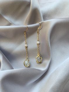 💖 ITEM INFORMATION 💖  *14K gold plated hook and chain connecting a white pearl and opal stone. The wire twist/spiral on the surface of the stone adds another layer to the design. *Length: 4.7 cm ✈️ SHIPPING INFORMATION ✈️  *All products are made in British Columbia, Canada, where I will ship the earrings. The processing time before dispatch takes 1-2 business days. The following shipping timeframe only represents an estimate, and please keep it in mind when you place an order.  ALL ORDERS ARE Cheap Gold Earrings With Pearl Chain, Metal Earrings With Pearl Chain As Gift, Metal Earrings With Pearl Chain For Gift, Metal Pearl Chain Earrings As Gift, Pearl Dangle Earrings With Adjustable Chain, Gold Dangle Pearl Earrings With Adjustable Chain, White Pearl Earrings With Adjustable Chain For Gift, White Long Drop Earrings With Adjustable Chain, Gold Pearl Earrings With Adjustable Chain