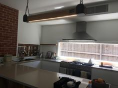 a kitchen with a stove top oven sitting under a window