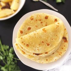 three tortillas on a white plate with parsley