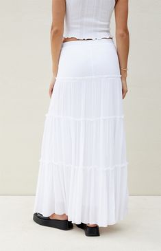 Beverly & Beck offers a boho-chic update to your casual style with their Tiered Maxi Skirt. This classic high-rise maxi skirt has a textured woven fabric and a tiered ruffled body for a modern update.    	37" center front length 	Lined 	Textured woven fabric 	High-rise 	Tiered ruffle body 	Self: 100% rayon; Lining: 100% cotton 	Model is wearing a size small Long White Ruffle Skirt, Luau Party Outfit, Gracie Concert, Thrift Shop Outfit, Boho Midi Skirt, Long White Skirt, White Ruffle Skirt, School Wishlist