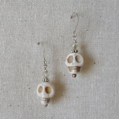 "White magnesite stone skull beads are wire wrapped and linked with silver daisy beads, seed beads and clear crystal bi cone beads on silver plate ear wires. Add a touch of the macabre for Halloween delight or enjoy for a year round Gothic look. The length of these earrings is a 7/8 \" dangle from silver plate on brass ear wires and the width of the skull bead is 3/8\". All of my jewelry items come boxed and lace ribbon tied and tagged for easy gifting. These earrings are ready to ship." White Skull-shaped Sterling Silver Jewelry, White Sterling Silver Skull Jewelry, White Bohemian Skull Jewelry, Daisy Beads, Earrings Gothic, Skull Beads, Earring Storage, Fabric Earrings, Earring Organizer