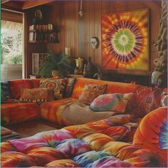 a living room filled with lots of colorful furniture and pillows on top of each other