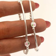 This charming jewelry sterling silver set features pink tulip charms, making it the perfect gift for bridesmaids or as a thoughtful graduation gift. You can gift this set as 16th birthday girl or a quinceañera girl as perfect and delicate jewelry gift . KEY FEATURES :   * Sterling silver Tulip charm /enamel (round 6mm)  * Highest-quality Sterling Silver heart charms (7mm)  * 3mm and 4mm Sterling silver Beads  * Sterling silver Tubes (30 and 40mm)   * Durable 1mm stretchy cord   * All  items feat Silver Dainty Charm Bracelet For Mother's Day, Sterling Silver Round Charm Bracelet For Wedding, Dainty Silver Charm Bracelet For Bridesmaid Gift, Dainty Silver Charm Bracelet For Mother's Day, Dainty Jewelry With Adjustable Flower Charm, Feminine Flower Charm Jewelry As A Gift For Her, Dainty Dangle Jewelry For Mother's Day, Adjustable Flower Charm Jewelry For Gift, Feminine Sterling Silver Jewelry Gift For Her