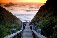 stairs leading down to the ocean at sunset