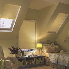 an attic bedroom with two beds and a desk