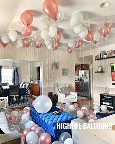 balloons are hanging from the ceiling in a living room