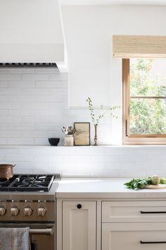 a kitchen with an oven, sink and window