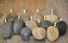 several different colored rocks sitting on top of a stone slab with one ring in the middle