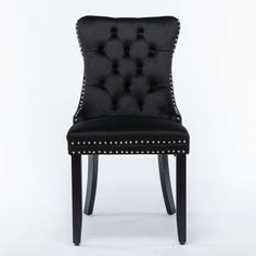 a black leather chair with studded trimmings on the legs and back, against a white background