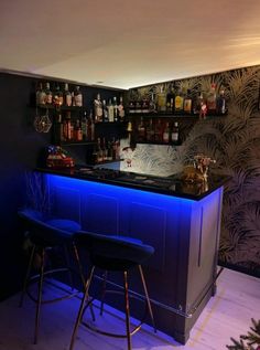 a bar with two stools in front of it