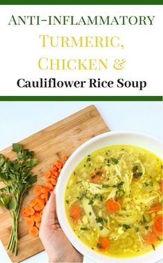 a person holding a bowl of chicken and cauliflower rice soup on a cutting board