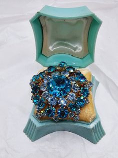 Very pretty layered rhinestone dome pin done in shades of aqua and light blue.  The stones are all prong set in bright gold washed metal.  This is a very attractive piece. The brooch is around 1 3/8 inches in diameter. This piece is in very nice condition.  No concerns noted. Free shipping in USA. Costume Jewelry Blue Brooches With Rhinestones, Vintage Blue Brooches With Rhinestones, Vintage Rhinestone Brooch, Mid Century Jewelry, Gold Wash, Bright Gold, Rhinestone Brooches, Blue Vintage, Vintage Rhinestone