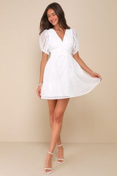 Let your adorable style and the Lulus Cultivated Cuteness White Burnout Gingham Tie-Back Mini Dress pave the way to an unforgettable summer! Lightweight woven organza boasts a burnout gingham pattern as it shapes short puff sleeves with elastic and ruffles at the cuffs. Fitted bodice has a V-neckline and chic pleated details, atop a banded waist with matching pleated accents. Turn around to reveal a flirty open back with a tie at the top. Flaring skirt finishes at a mini hem. Smocked panel and h