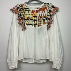 Nwt Off White Multicolor Embroidered Long Sleeve Top. Single Button Closure In Back Pleated Long Sleeves With Button Closure At Wrist Pineapple Embroidered Ruffle At Shoulders Embroidered Motif Lightweight 100% Cotton Crew Neck Measurements Are Flat Lay And Approximate. Bust 22in. Shoulders 15.5in. Length 25in. In Front, 26in. In Back Sleeves 27in. White Blouse With Embroidered Sleeves For Fall, White Embroidered Top For Fall, Fall Embellished White Tops, White Embroidered Cotton Top For Fall, Traditional White Embroidered Top For Fall, White Folk Embroidered Top With Embroidered Hem, Folk Style Embroidered White Top For Fall, Folk Style White Embroidered Top For Fall, White Embellished Long Sleeve Tops