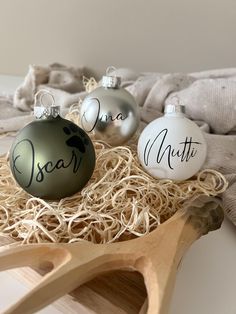 three christmas ornaments sitting on top of a wooden tray