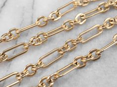 This long vintage gold paperclip chain is stunning, an elongated oval link chain with a soft patina. The craftsmanship is superb, creating a strong, well-made chain from which a watch or pendants can easily be hung.Metal: 14K Yellow GoldWidth of Chain: 6.0 mmLength of Chain: 31 Inches Elongated Oval, Metal Chain Link, Paper Clip, Link Chain, Vintage Gold, Patina, Chain, Yellow, Gold