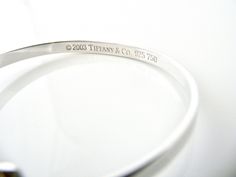 Overview: Offered for sale is a wonderful and gorgeous Tiffany & Co. Sterling Silver 18K Gold Heart Hook Bangle. Definitely a Tiffany piece that you will get your money's value for. It works perfectly with pretty much any attire your put on, AND is a great statement piece. The piece looks fabulous worn alone, but is also a wonderful piece with which to start or add to your Tiffany collection. Very versatile indeed! This piece is simple, elegant, and classic all rolled into one bracelet. Imag Bangle Silver, Hook Bracelet, Gift Love, Gold Heart, Heart Of Gold, Bracelet Gift, Tiffany & Co., Classic Art, Statement Pieces