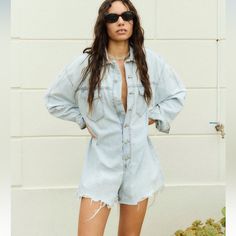 Short Jumpsuit With Lapel Collar And Long Cuffed Sleeves. Chest Patch Pockets. Ripped Detail. Unfinished Hem. Front Metal Button Closure. Blue | 4365/080 Light Wash Button-up Jumpsuits And Rompers For Spring, Spring Light Wash Button-up Jumpsuits And Rompers, Light Wash Button-up Denim Jumpsuit For Spring, Spring Light Wash Button-up Denim Jumpsuit, Summer Button-up Medium Wash Jumpsuits And Rompers, Spring Button-up Light Wash Denim Jumpsuit, Summer Cutoff Overalls With Pockets, Spring Denim Blue Button-up Overalls, Summer Denim Button-up Jumpsuit With Pockets