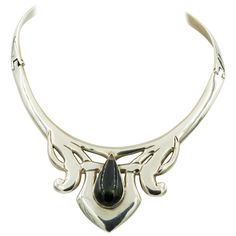 This stunning necklace has a modernist design in the center with a pear shaped rainbow obsidian in the center. It is hinged on both sides and closes with a push in clasp at the back. The collar's inside measurement is approximately 14.5". The ornament area measures 2.72" across by 1.82" tall. Marked Mexico TD-27 925 Alicia de la Paz Biography from Novica: "I was thrust into the realm of jewelry-making and soon enough the Mexican government awarded us... the prestigious national quality distinction award." "I was born in Taxco, the crib of Mexico's silver artistry. I went to Mexico City to study a career in law, and I also studied art and poetry – I actually won first and second places in various national and state art contests which led me to pursue my artistic side. I attended several wor Rainbow Obsidian, When I Get Married, Modernist Design, First Daughter, Art Contest, Stunning Necklace, Collar Necklace, State Art, Paper Design