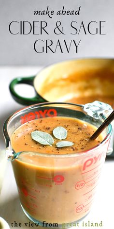 a close up of a cup of food on a table with the words make ahead cider and sage gravy