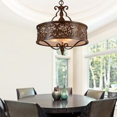 a chandelier hanging from the ceiling in a dining room