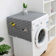 a white washer sitting next to a dryer on top of a wooden floor