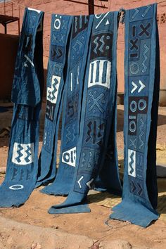 three blue cloths are hanging on a clothes line in front of a brick building