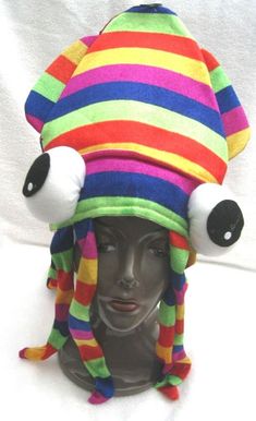 a multicolored hat with two eyes on top of a mannequin's head