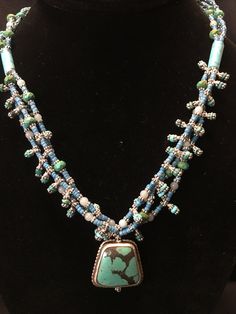 "Artist: Teresa Bradford Length: 18\" Turquoise Beads, Mali africa Trade seed beads circa 1940's Soft Blue Larimar, Silver Placers. In My Studio Creating with the color Blue Such a Tranquil Presence. ❤ Teresa Bradford-Cole Sacred Beaded, Modern Tribal Jewelry My work is emotional and passionate, weaving moments of the past, moments of the present, Visions of the future, cultivating & manifesting. Creating art to wear, to embrace the sacred shaman within. We are our own shaman. I am intense, Artisan Hand-strung Turquoise Necklace For Festivals, Artisan Beaded Turquoise Necklace, Spiritual Beaded Turquoise Necklace For Festivals, Artisan Beaded Turquoise Necklace For Festivals, Bohemian Hand-strung Turquoise Necklace For Festivals, Artisan Turquoise Necklace With Large Beads For Festival, Traditional Hand-strung Turquoise Necklace For Festival, Artisan Turquoise Necklace For Festivals, Handmade Artisan Turquoise Necklace For Festivals