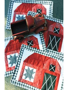 four quilted placemats with an old car on one side and stars on the other