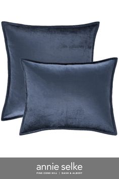 two dark blue velvet pillows with the name annie selke