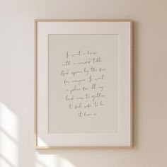 a handwritten poem is hanging on the wall next to a vase and potted plant