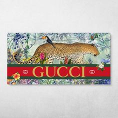 a gucci sign with a leopard and flowers on it's side, in front of a white wall