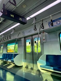 an empty train car with blue seats and windows