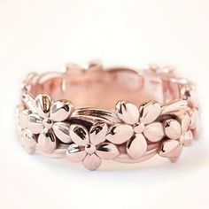 a close up of a ring with flowers on it