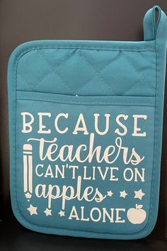 a teal blue bag with white writing on the front and bottom that says because teachers can't live on apples alone