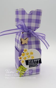 a purple and white checkered box with a butterfly on the top that says happy easter