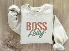 Boss Lady sweatshirt in Boho colors!  For chilly summer evenings and warm winter layers, sweatshirts are a staple item all year round. The NuBlend; fleece is pre-shrunk, pull-resistant, and quarter-turned so it won't crease in the middle. Made from 50% polyester and 50% sustainably sourced USA cotton, they're very soft to the touch. .: 50% cotton, 50% polyester NuBlend; pre-shrunk fleece .: Medium-heavy fabric .: Regular fit S M L XL 2XL Width, in S 20.00 M 22.00 L 24.00 XL 26.00 2X 28.00 Length, in S 27.00 M 28.00 L 29.00 XL 30.00 2X 31.00 Sleeve length from center back, in S 34.50 M 35.50 L 36.50 XL 37.50 2X 38.50 Boss Lady Svg, Inspirational Svg, Goal Digger, Motivational Svg, Comfort Colors Sweatshirt, Winter Layering, Womens Crewneck, Colorful Boho, Svg Cricut