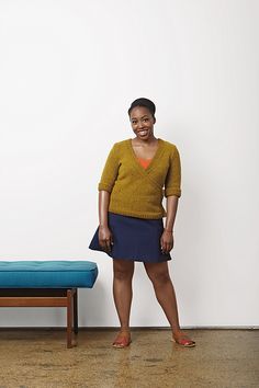 a woman standing in front of a bed with a blue mattress on the floor next to it