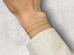 ✨ This delicate beauty features a sleek snake chain design that effortlessly complements any outfit. Perfect for everyday wear or special occasions, this bracelet is a must-have for fashion-forward women. 🌟 💫 Why You'll Love It: Elegant Design: Simple yet sophisticated gold color. Durable & Stylish: Made from high-quality stainless steel. Versatile Wear: Ideal for layering or wearing solo. Treat yourself or someone special to this chic accessory! 💖 Flexible Adjustable Minimalist Chain Bracelet, Minimalist Snake Chain Bracelet With Adjustable Chain, Minimalist Flexible Chain Bracelet As Gift, Minimalist Adjustable White Chain Bracelet, Minimalist White Adjustable Chain Bracelet, Minimalist White Bracelet With Delicate Chain, Adjustable Dainty Snake Chain Bracelet, Dainty Adjustable Snake Chain Bracelet, Minimalist Flexible Chain Bracelet For Everyday