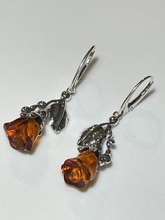 * 100% Natural Baltic Amber, 925 Sterling Silver. * Earring Total Length: 50 mm (2.0"), Width: 17 mm (0.7"). * Stones size: 11 mm x 9 mm  (0.43" x 0.35") . * Total Weight: 7 gram. * Perfect amber jewelry gift for her.  * Color: Honey. * These Earrings are for adults only. Natural Baltic Amber Rose Earrings. Elegant Drop Rose Natural Baltic Honey Amber Earrings. Did you know that Amber was one of the first materials ever used for accessorizing? Ornaments made out of amber were found on prehistori Prehistoric People, Natural Jewelry, Amber Rose, Amber Earrings, Tiny Earrings, Stone Age, Earrings Elegant, Jewelry Sterling Silver, Amber Jewelry