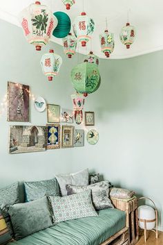 a living room filled with furniture and hanging lanterns