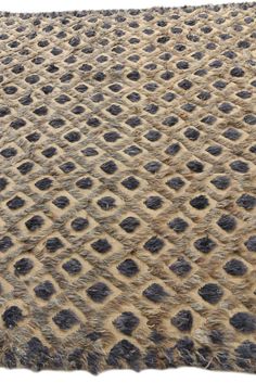 an animal print rug with black spots on it