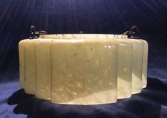 a large yellow piece of soap sitting on top of a blue cloth