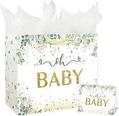 a white bag with gold foil lettering on it and a baby card in front of it